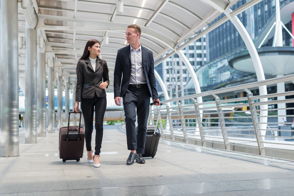 Business travellers with luggage for Hereford taxi transfers